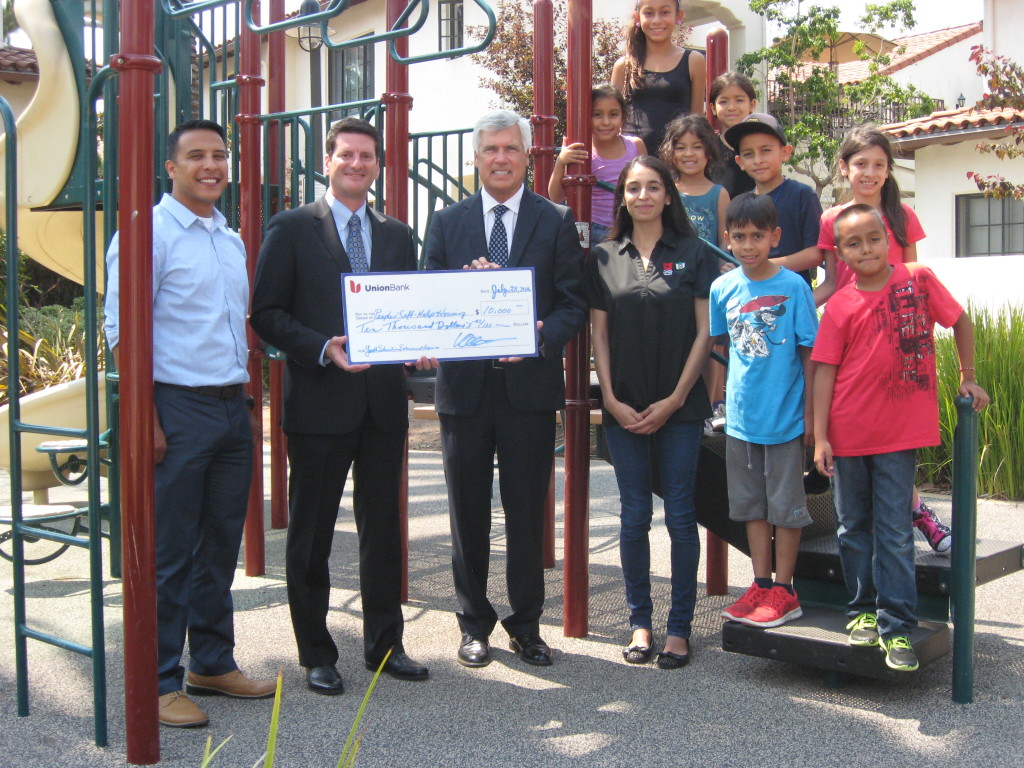 Vince Caballero, Union Bank Managing Director/Region Manager, left of the check, presents $10,000 to Peoples’ Self-Help Housing President/CEO John Fowler, along with students and educators from PSHH’s Youth Education Enhancement Program. Courtesy photo.