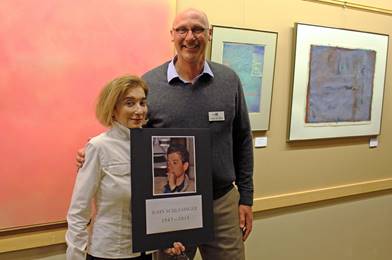 From left, Mary Schlesinger, sister of late artist of John Schlesinger, and David Selberg, HSB CEO. Mary is holding a photo of her brother. Courtesy photo.